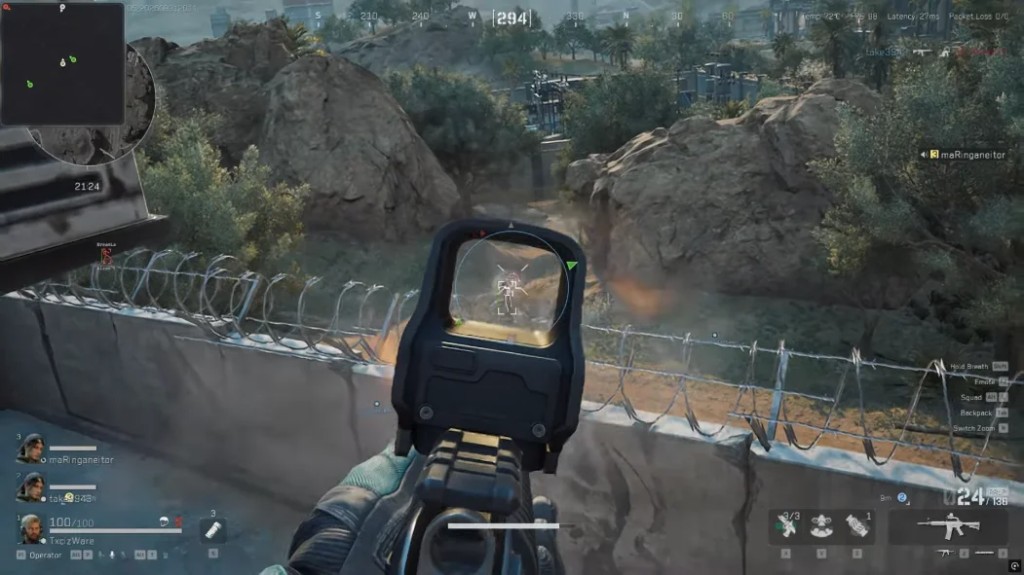 Holographic sight on an enemy with a white skeleton overlay and a red distance marker outside the reticle.